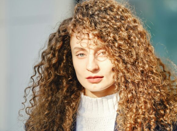 Portrait of a woman with brown curly hair