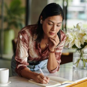 Woman Writing down Plans for the Day