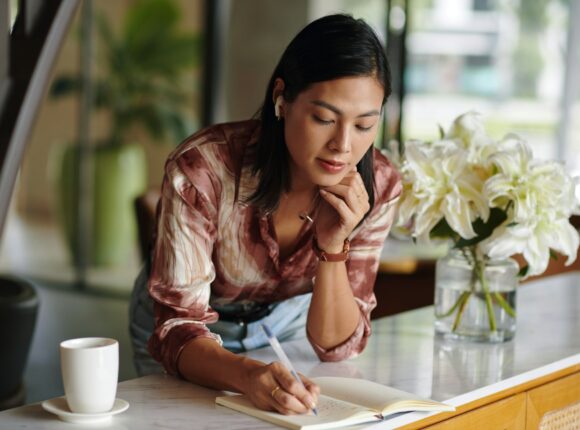 Woman Writing down Plans for the Day