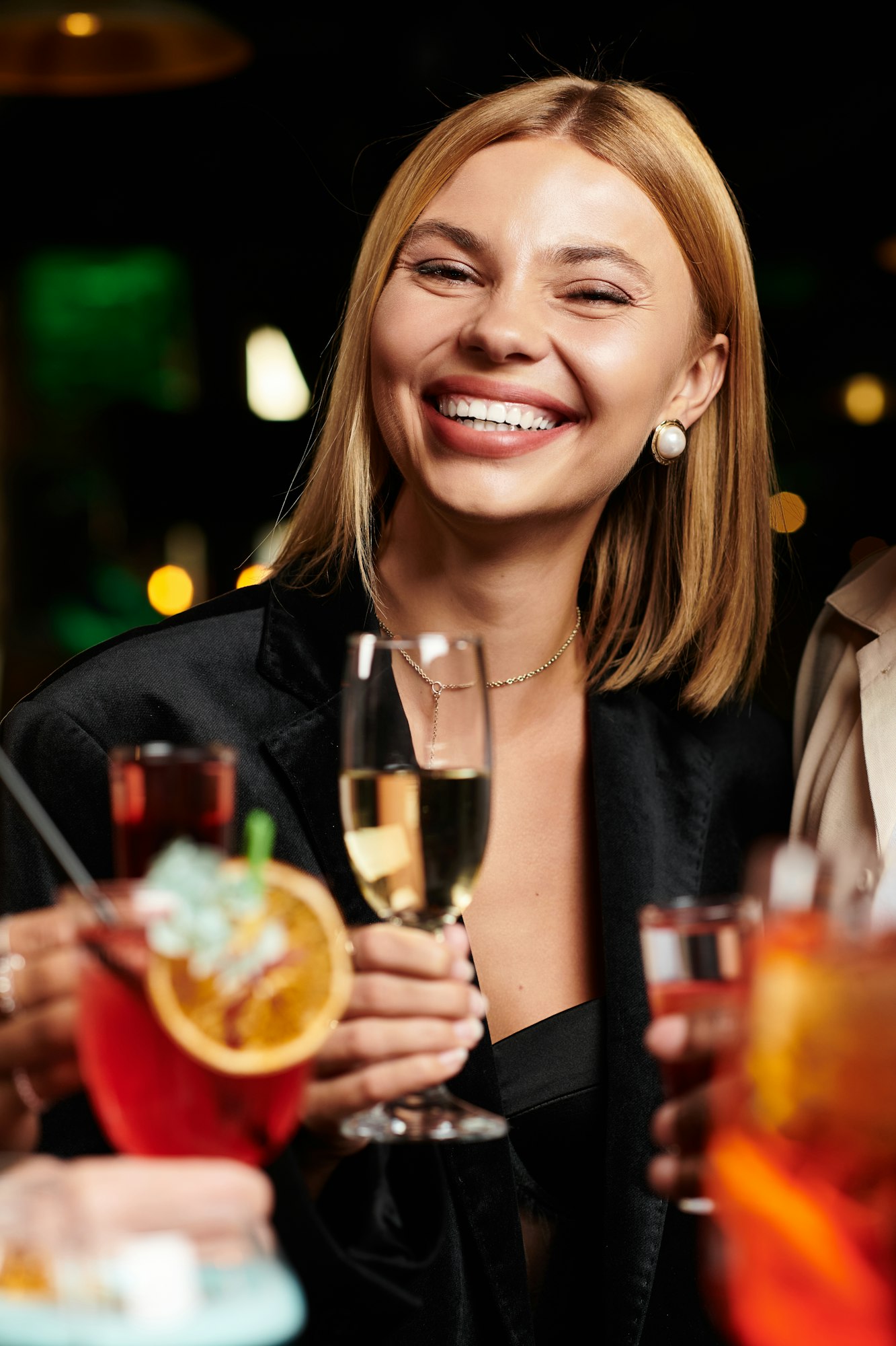 Young diverse colleagues celebrate at a corporate party with smiles and festive drinks